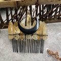 Macro view of handmade black crescent moon hair comb with raw orange crystal points - Citrine Crystal Black Moon