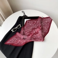 Detail of pleated burgundy paisley satin scarf arranged with fashion accessories - Red Paisley