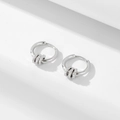 Elegant silver hoop earrings with three dangling cubic zirconia circles on white background - 925 Silver / White