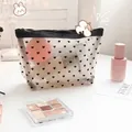 Detail of semi-transparent heart pattern mesh makeup bag showing interior cosmetics - Flocked Heart Beige (Large Triangle)