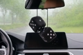 Close-up of black plush car dice hangers with pink heart patterns hanging on rear view mirror - Black Pink Heart