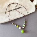 Detail of handmade green apple beaded necklace with adjustable rope and star accents - Brown Wax Cord Green Star Button Apple Pendant Necklace