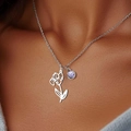 Collana d'argento con ciondolo floreale e gemma viola indossata da una modella - Febbraio