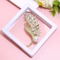 Golden feather brooch with shimmering crystals and elegant pearl accent on display - XZ166-Gold Leaf Feather-Boxed