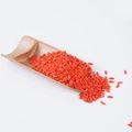 Orange simulation rice PVC grains displayed on a natural bamboo tea scoop accessory - Red Simulation Rice (500g)