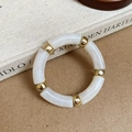 Detail of marble pattern resin segments and golden metallic spacer beads on the bracelet - Round Splicing / White