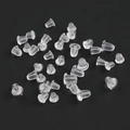 Macro shot of bulk transparent silicone earring backings on a dark grey background - Clear Earring Backs / 100 Pcs Per Pack