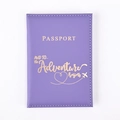 Detailed view of purple PU leather passport cover with gold adventure text and plane logo - Purple