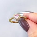 Macro shot of pink heart gemstone ring with gold band and pave-set cubic zirconia detail - Size 5 / Gold + Pink Zirconia