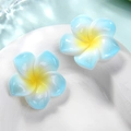 Blue and yellow gradient resin plumeria flowers on a white plate with water background - L Blue