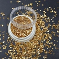 Macro shot of gold irregular flakes for nail art and DIY crafts in a white storage jar - 1.5-3MM Canned / Electroplated Gold