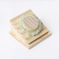 Light green beaded bracelet with crackle effect on a tiered wooden display stand - 1910 Cylindrical Bracelet Holder