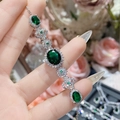 Close-up of emerald style bracelet with green oval gemstones and silver plating - Oval Multi-Section Link Style (0053)