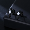 Close-up of black gothic cross stud earrings with matte finish and white stone inlay - Single Piece / Ivory
