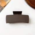 Detail view of a matte brown square hair claw clip on a minimalist white table setting - 10.5cm / Matte Dark Coffee