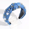 Detail of blue knotted headband with white pearls and sparkling rhinestone heart accents - Blue