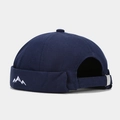 Detail of navy blue miki hat showing white mountain embroidery and metal buckle strap - Navy Blue