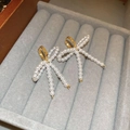 Elegant gold bow earrings with white pearl tassels on a grey velvet jewelry tray - Gold Pearl Bowknot Tassel Ear Buckle (9# Ear Buckle - Gold - White)