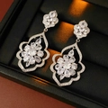 Close-up of silver tassel earrings with flower and leaf zircon crystals in a jewelry box - Silver Hollow Flower Inlaid Rhinestone Studs
