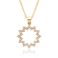 Detailed macro view of an 18k gold plated starburst pendant set with white zircons - Hollow Pointed Star Style (c488)