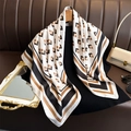 Detail of square silk scarf with geometric pattern draped over a luxury handbag - 90x90cm / White