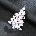 Detailed close-up of a white enamel Christmas tree brooch with colorful rhinestones - Silver Christmas Tree