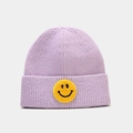 Gros plan du bonnet en tricot violet avec un écusson smiley jaune brodé sur le devant - Mauve Clair