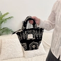 Close-up of black and white polka dot plush handbag with fuzzy sheepskin texture detail - Ethnic Style Totem