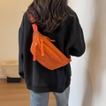 Orange canvas chest bag with embroidered letters shown in a trendy casual crossbody style - Orange