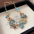 Gold starfish shell necklace with blue enamel and pearls in a black jewelry gift box - Gold Blue Enamel Rhinestone Pearl Starfish Shell Coral Necklace