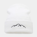Detailed view of white knitted beanie featuring black mountain range embroidery on cuff - White
