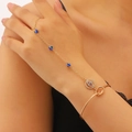Detail of gold evil eye hand chain featuring blue beads and rhinestone charm on a model - 60kc Gold N-912 (evil Eye)