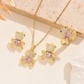 Close-up of golden bear jewelry set with pink heart gems and micro-pave zircons - Gold