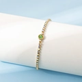 Elegante pulsera de acero inoxidable bañada en oro de 18K con circón verde y cristales - Agosto / Peridoto