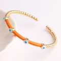 Chic gold-plated Evil Eye open bangle with vibrant orange enamel and bead chain details - Orange