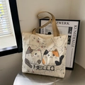 Beige canvas tote bag featuring cute cartoon cat prints and sturdy brown handles - Beige All-over Cat Print HELLO