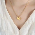 Gold snake chain necklace with Good Luck round tag and zircon moon charms on a model - 45+5cm / Gold