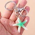 Starfish keychain with white and green resin pendant on silver metal hardware - White Green Starfish