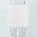 Detailed view of the white mini skirt featuring intricate 3D rose flower applique design - S / White