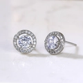 Elegant silver round stud earrings with white zircon and pave setting on marble background - Round Rhinestone