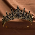 Detail of vintage gold crown featuring luxury black rhinestones on brown silk - Antique Black