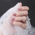 Close-up of dusty rose square press-on nails paired with elegant silver rings - Shiny Morandi Pink (DFL-09)