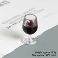 Macro detail of miniature 38x21mm wine glass resin charm with simulated red liquid - Dark Red