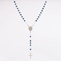 Macro detail of sapphire blue crystal beads and silver rosary cross pendant necklace - Blue