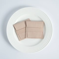 Detail view of pink microfiber suede jewelry pouches on a minimalist white ceramic tray - Rosy Pink