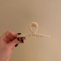 Matte beige large hair claw clip with golden spring shown in hand for women - Large 11.5cm / Milky White