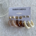 Golden earrings set with pearls and resin hoops on a white fashion display card - KC Gold (0082)