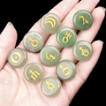 Green aventurine stones set with ten golden solar system planet symbols held in hand - Green Aventurine / 10 Pieces Pack