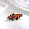 Macro detail of enamel monarch butterfly brooch with gold plating and vibrant textures - DB003-A (Black Orange Blue Butterfly)