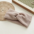 Close-up of thick knitted twist knot headband in soft light brown wool texture - Pink